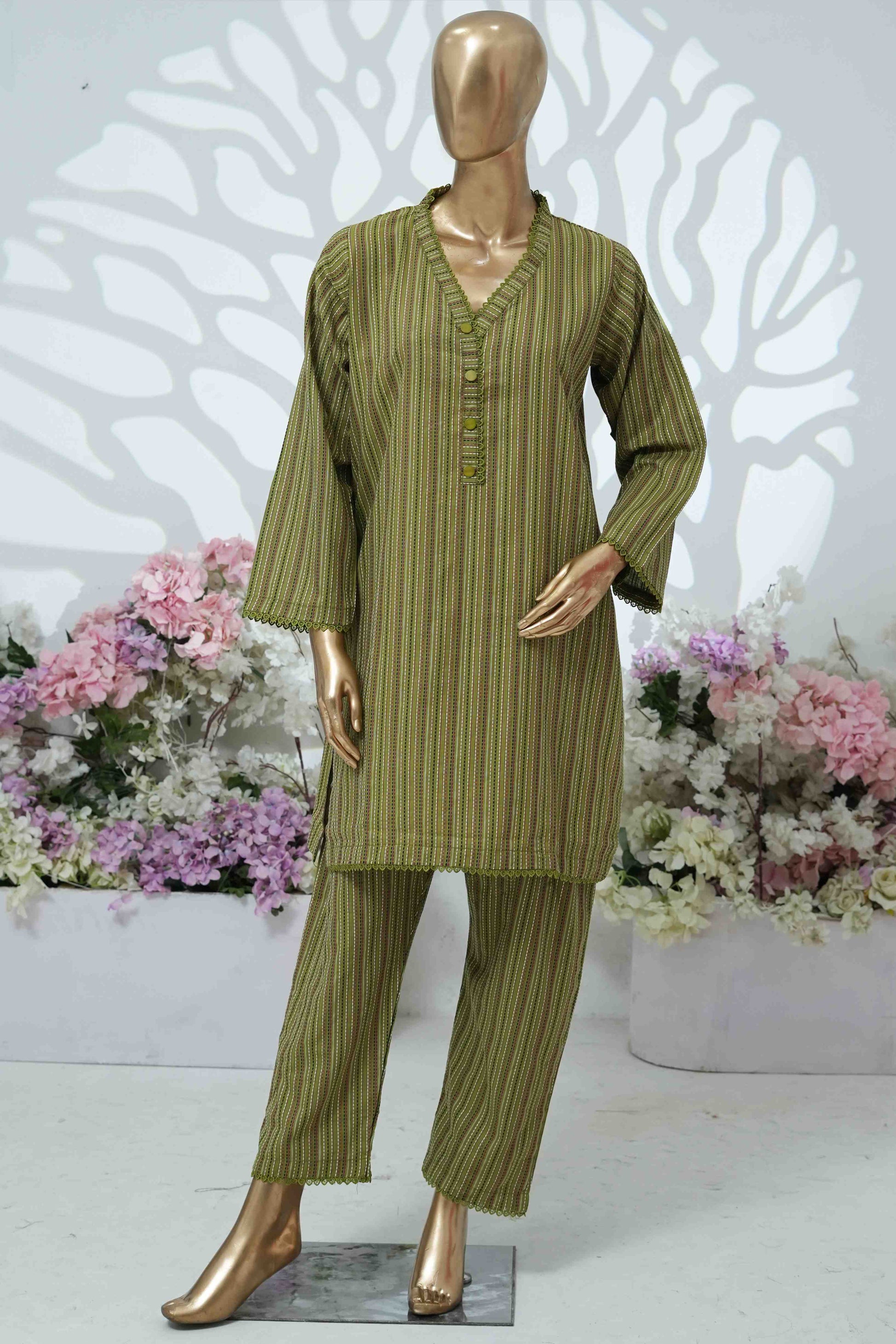 Mannequin wearing a green striped outfit with flowers in the background